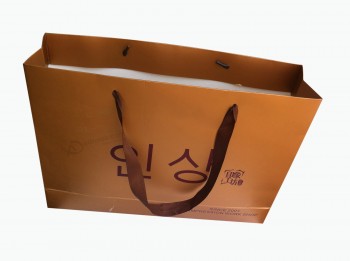 リボンハンドル付きのユニークなゴールデンカラープリント紙袋用の卸売りカスタムロゴ (YY-B0120)