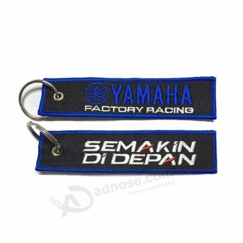dongguan cheap promotion gift oem company logo name motorcycle key holder ring chain fabric tag custom embroidery keychain