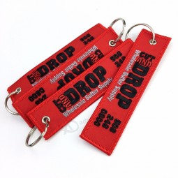 Wholesale csutom polyester fabric type embroidered key chain custom keyring with your own logo