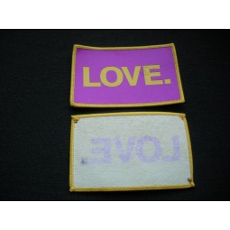 Factory direct wholesale customized top quality Purple Background White Text Overlocking Woven Badge