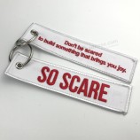 High quality custom double logo design fabric embroidery keychain for traveling