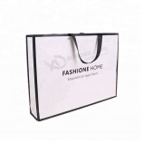 強い白い注文の自身の設計はロゴおよびリボンのハンドルが付いている贅沢なショッピング包装のpaperbagを印刷しました