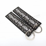 merrow border Schlüsselanhänger aus gewebtem Stoff mit doppelseitigem Buchstabenlogo für Handtaschen