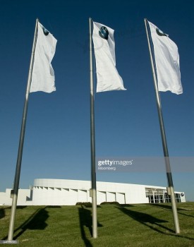 Flags fly in front of the BMW Visitors Center on the campus