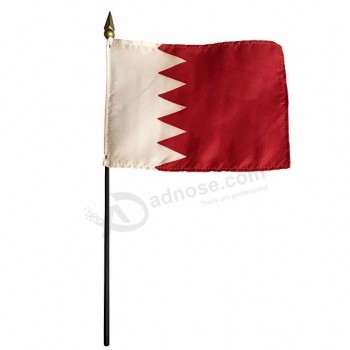 Small Bahrain hand country flag with wooden flag pole