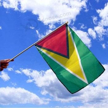 Poliéster país nacional Guyana mano sacudiendo la bandera
