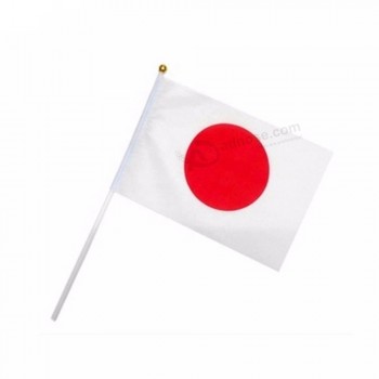 bandiera tenuta in mano nazionale della bandiera dei bastoni del paese del Giappone