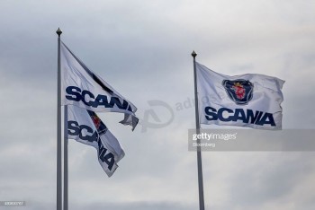 Scania branded flags fly outside the headquarters of Scania