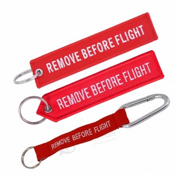 Etiquetas de llavero personalizadas con quitar antes del vuelo Llaveros