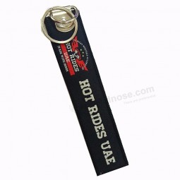 merknaam promotionele reizen souvenir geweven logo stof sleutelhangers