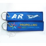 groothandel promotionele aangepaste geborduurde stof sleutelhanger