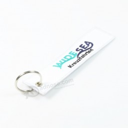 Custom white embroidery cool keychains with three colors on logo