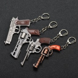Il revolver dell'automobile della pistola dell'arma del keychain 3D mangia il gioco all'ingrosso del pollo