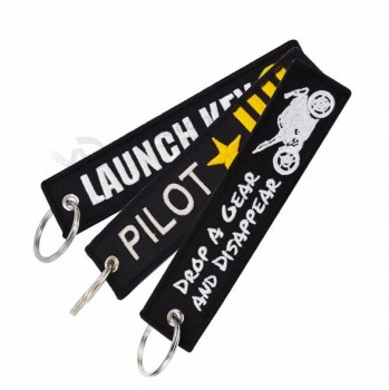 Supprimer Avant le vol nouveauté lancement porte-clés pour motos voitures porte-clés broderie OEM Suivez-moi porte-clés bijoux étiquette de bagages