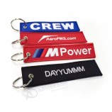 Goedkope op maat gemaakte stof Pre-take-off ontmanteling sleutelhanger sleutelhanger dubbelzijdig logo geweven label borduurwerk sleutelhanger